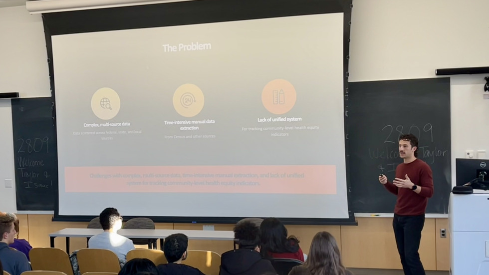 A man presenting at the front of a classroom